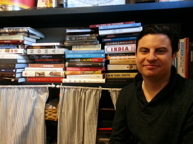 Matt Gallager with his cookbooks in his Knoxville restaurant Knox Mason.