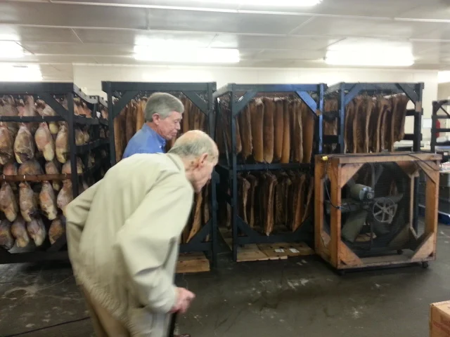 In this picture, Allan shows my father around Benton’s Smoky Mountain Country Hams in Madisonville, Tennessee.