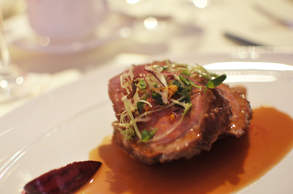 Seared duck breast with brioche pudding and orange essence