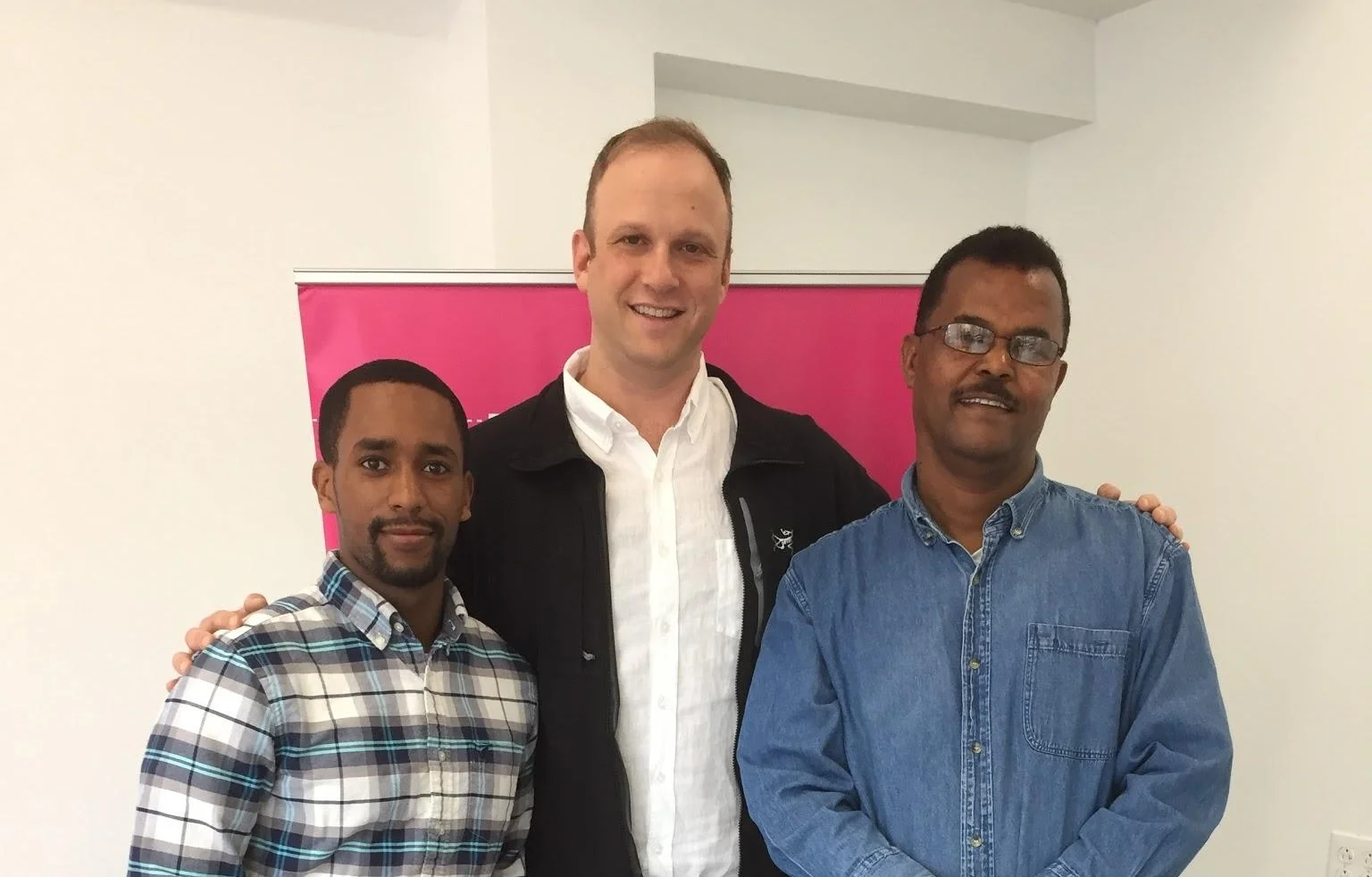 Abraham’s son, Harouc, (left), Philadelphia General Manager, Andrew (center), and Abraham (right), contest winner, at the Lyft Philly office.