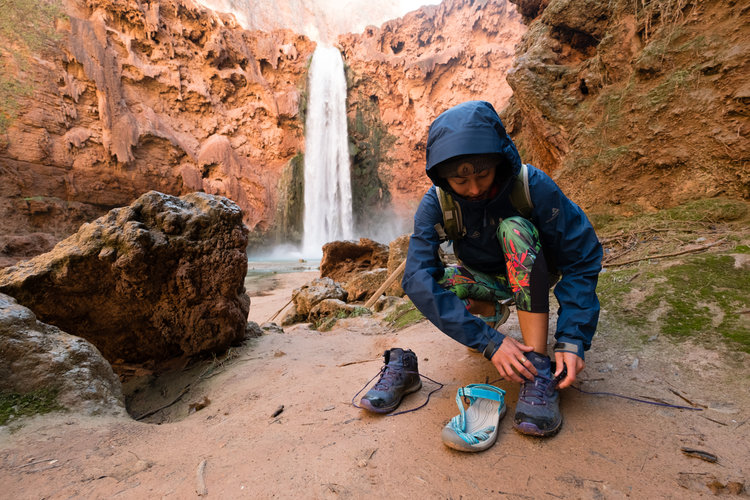 Switching shoes at the base of Mooney Falls. Photo By Travis Burke