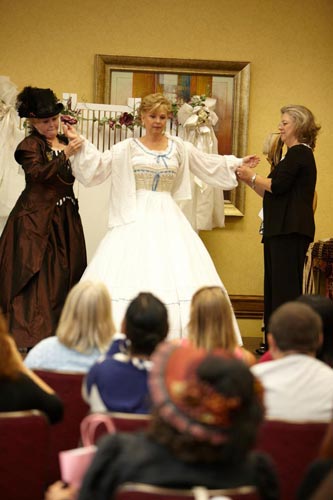 Dee is dressed by her lady's maids (J'Nean and Gayle).