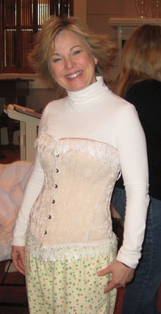 Cathy Marie Hake had brought some modern-day corsets and strapped me into one. You can tell it's modern-day because it covers the breasts. The period ones only lifted, but did not cover. Looks nice with my flannel pjs, huh? :P