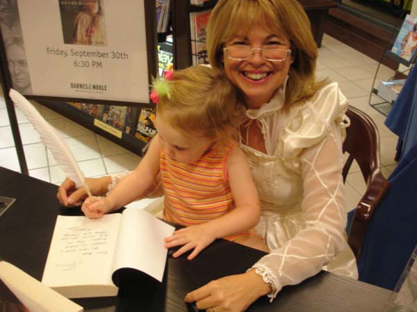 "Princess Dee" receiving help with her inscription from "Princess Sydney." (The quill didn't have any ink on it, but Sydney didn't seem to mind.) Isn't she the most precious thing ever? I was very reluctant to give her up.