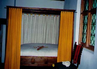   Another view of the bed, the bed curtains and the bed key. The window is a reproduction of the diamond-paned ones originally in the house.  