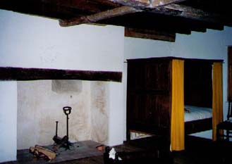   Here is a view of the master chamber's fireplace. I can't find in my notes what they call that thing in the fireplace (maybe somebody can email me), but it was used to warm up your brandy. You'd set the bottle in it until it reached the temperature