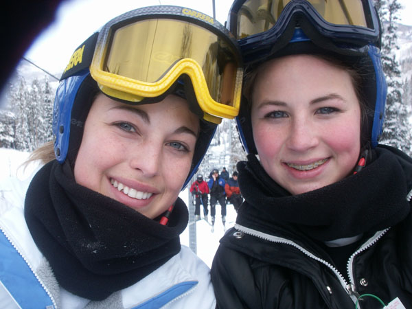 The girls take a picture of themselves on the chair lift.