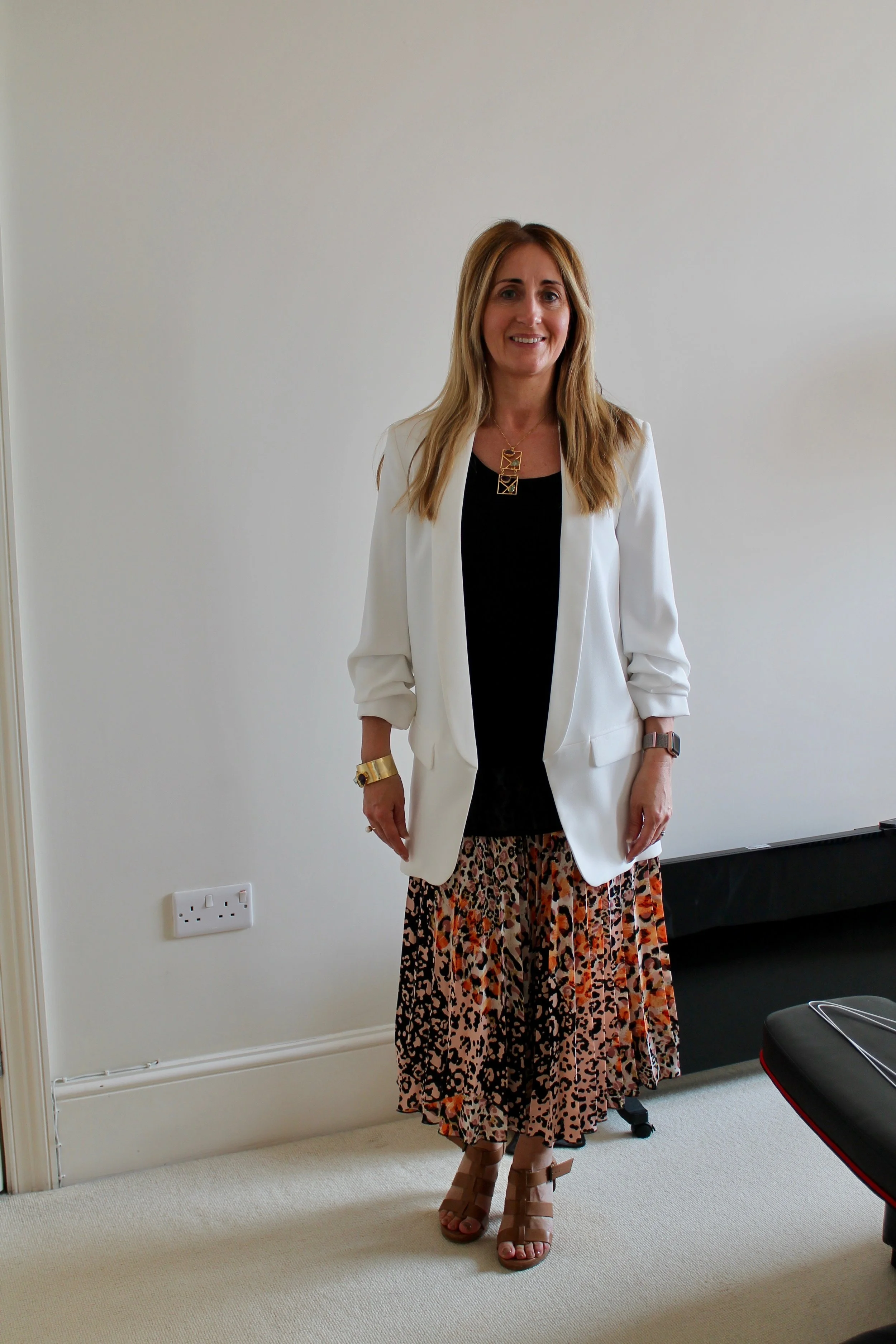 A new look for Katie. Printed pleated skirt and long line blazer. Modern yet totally suitable for her working day.