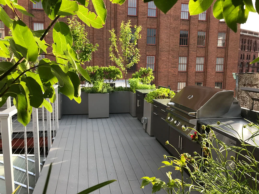 Kitchen garden with grill, side burners, refrigerator and sink.