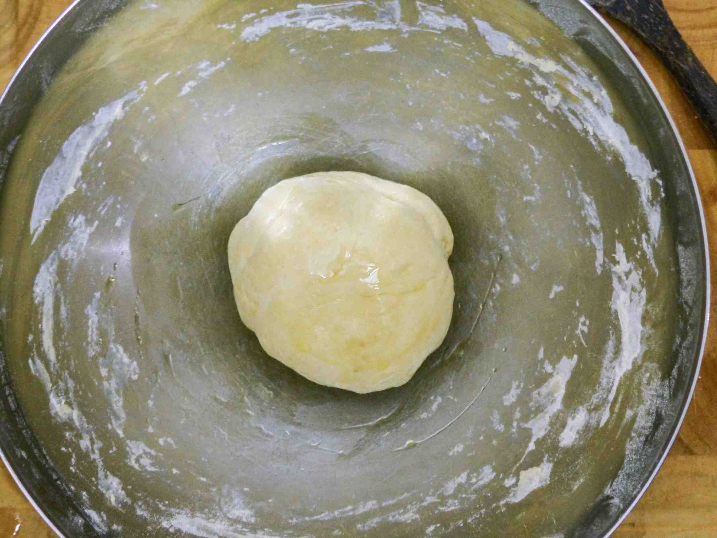 Transfer the dough to a lightly oiled bowl then cover with a damp towel and let it rise for 1 hour. 