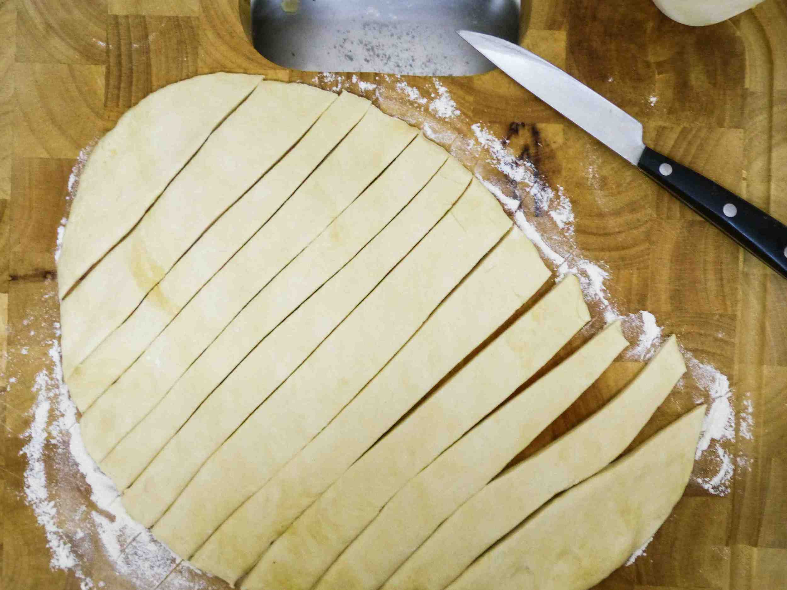 After rolling out the dough to a flat sheet, cut the sheet into 10-12 strips. 