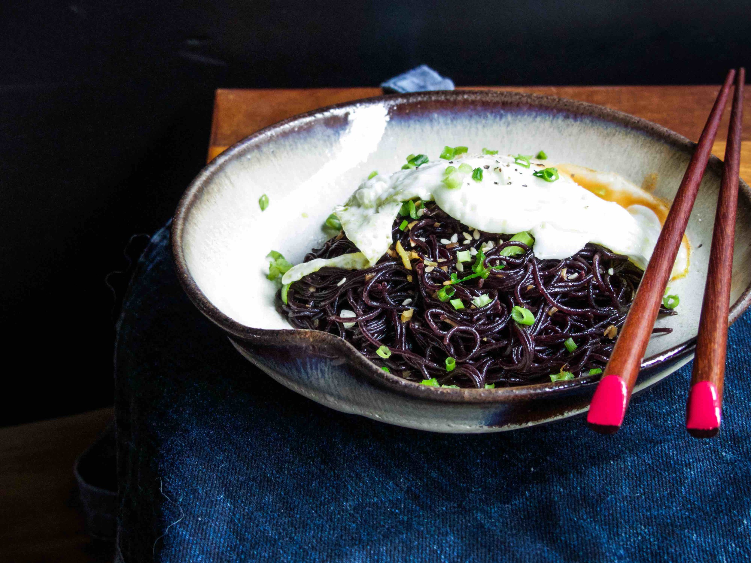 Recipe for "the budget ramen dish" Servings: 1 person Preparation Time: 2 minutes Cooking Time: 3-4 minutes Ingredients: 1 black rice ramen cake, cooked according to the packaging label (3 minutes) 1/2 garlic clove, finely chopped 1 tsp grated fresh ginger 1 tbsp chopped spring onion 2 tbsp soy sauce 1 tbsp honey 1 tsp rice vinegar 1 tsp sesame oil 1 tsp sesame seeds 1 egg, sunny side up hot sauce Instructions: 1) To make the sauce to go with the cooked ramen, simply add sesame oil, soy sauce, honey, rice vinegar, garlic, and ginger. Mix well. 2) Coat the ramen with sauce and add an egg. Garnish with sesame seeds and spring onion. Add a dash of hot sauce to give an extra kick of this simple dish before serving. 