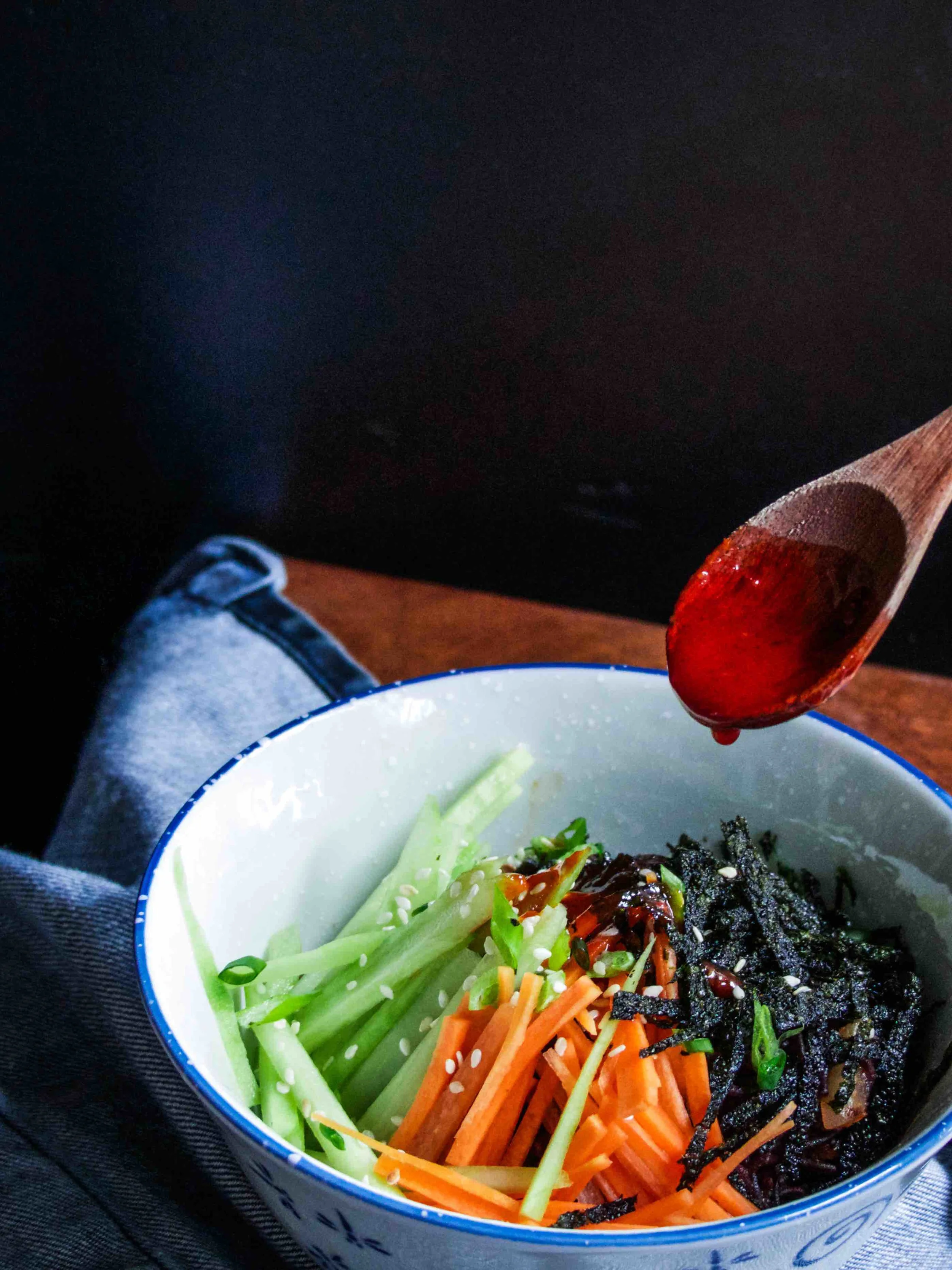 Organic Black Rice Ramen (Wheat & Gluten Free) with shredded dried seaweed, cucumber and carrot in Momofuku's Red Dragon Sauce. 