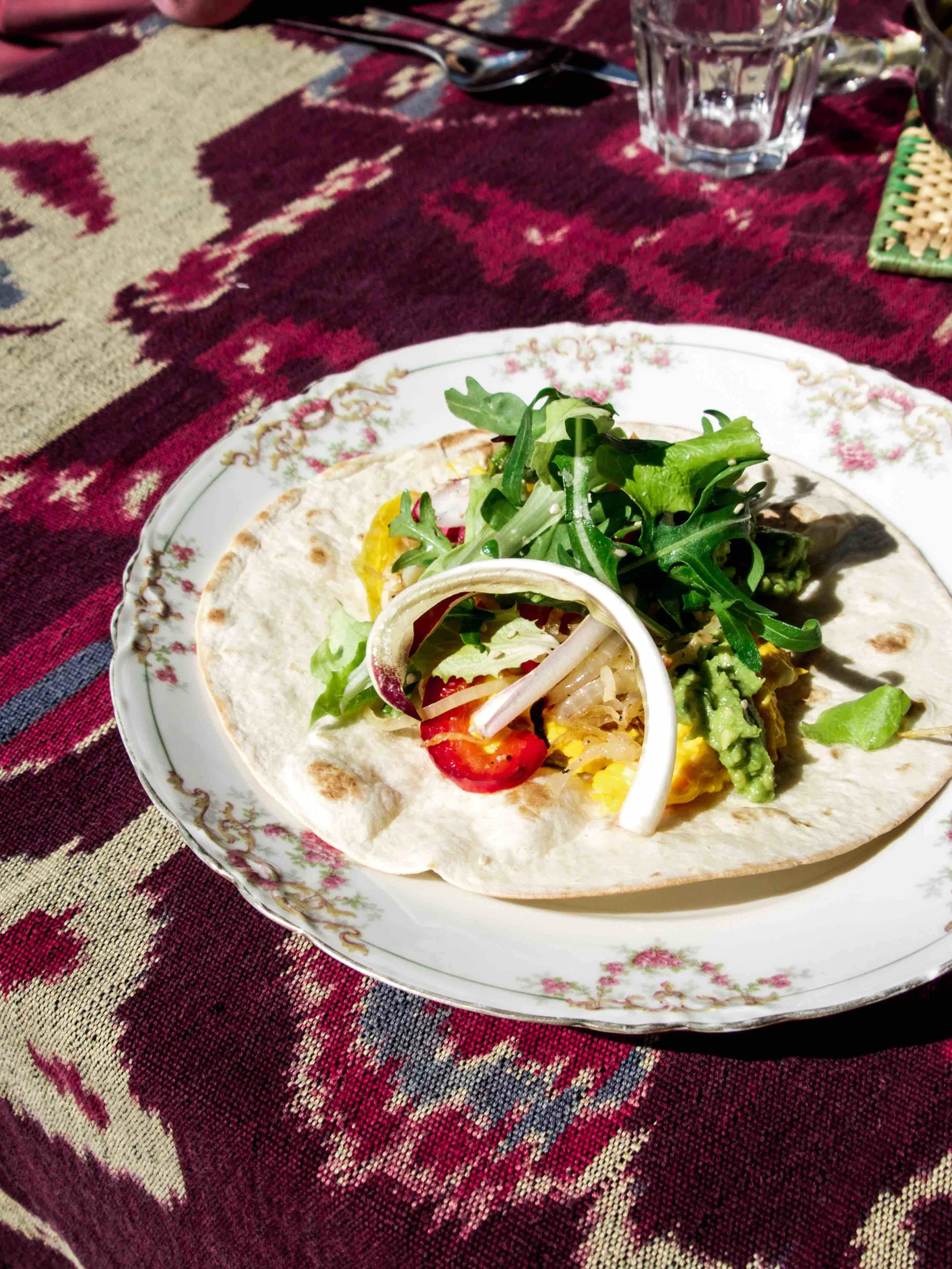 At last, the best and favorite meal of the week -- fresh guacamole, scrambled egg (fresh from Marco's grandmother's chicken), caramelized onion, and mixed greens on a tortilla wrap
