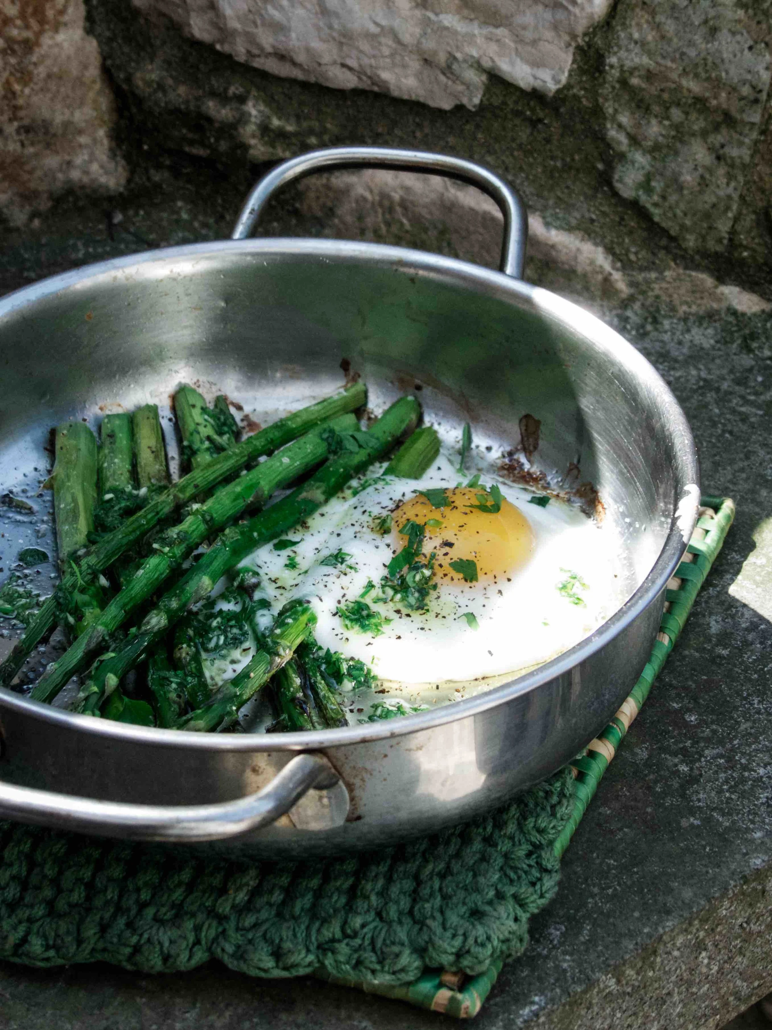 This dish is so easy to make. Not much technique nor preparation is needed. Season the asparagus with olive oil, salt and pepper. Roast for about 15 minutes at 180-200ºC in oven and crack an egg to the baking dish and roast for a few more minutes before serving. 