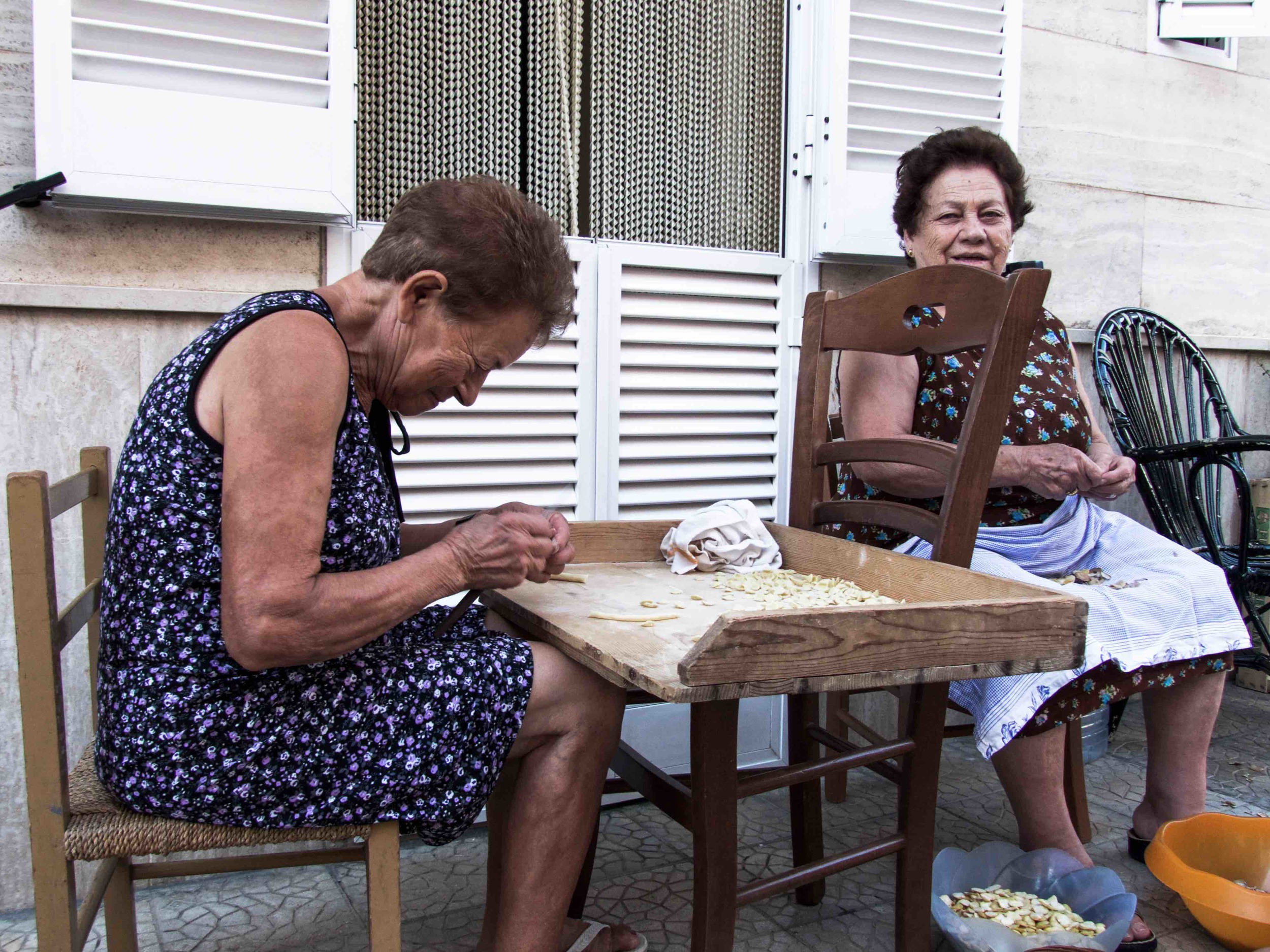 Nonne making children-sized orecchiette for their grandchildren.