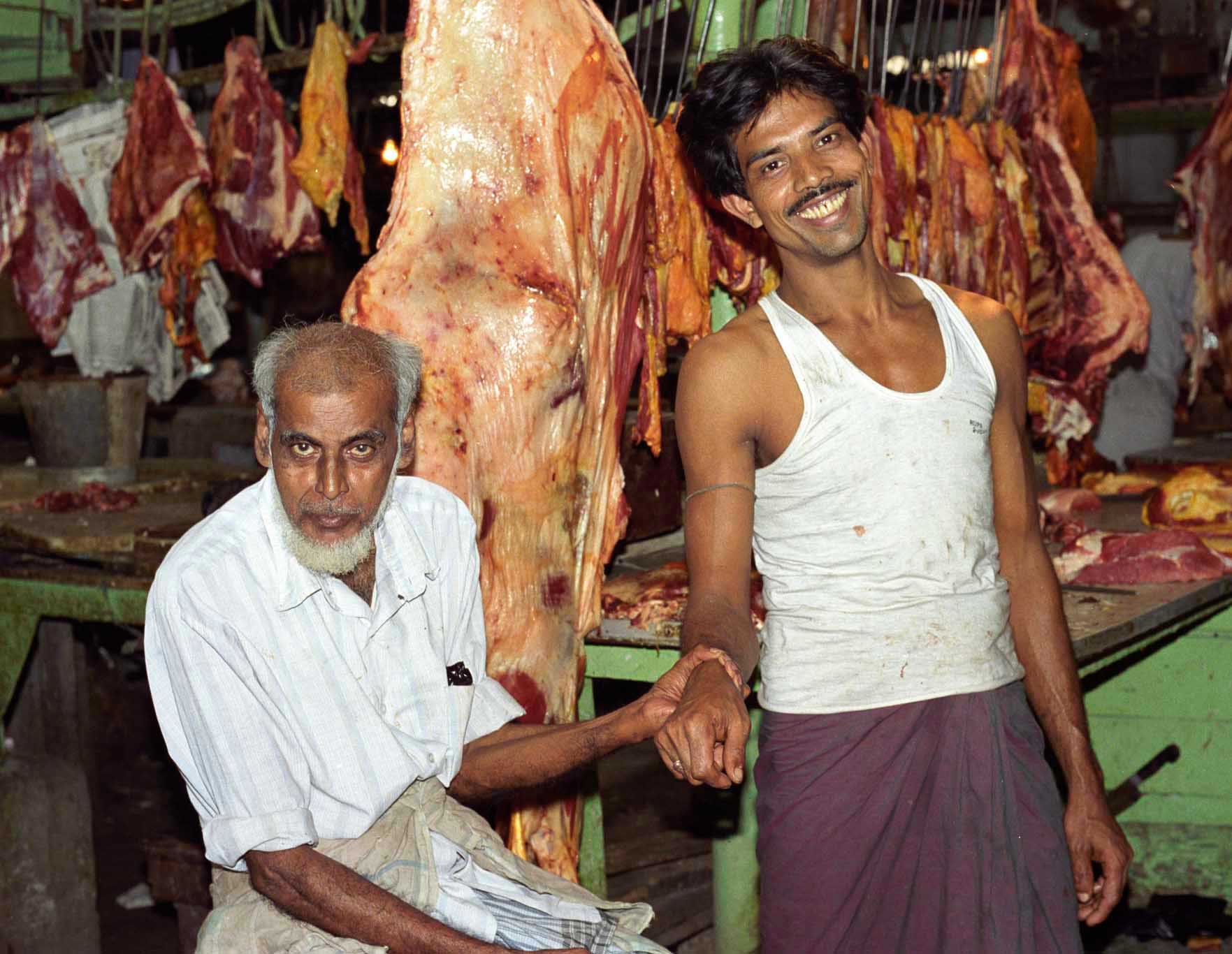 Father and son in Calcutta meat market