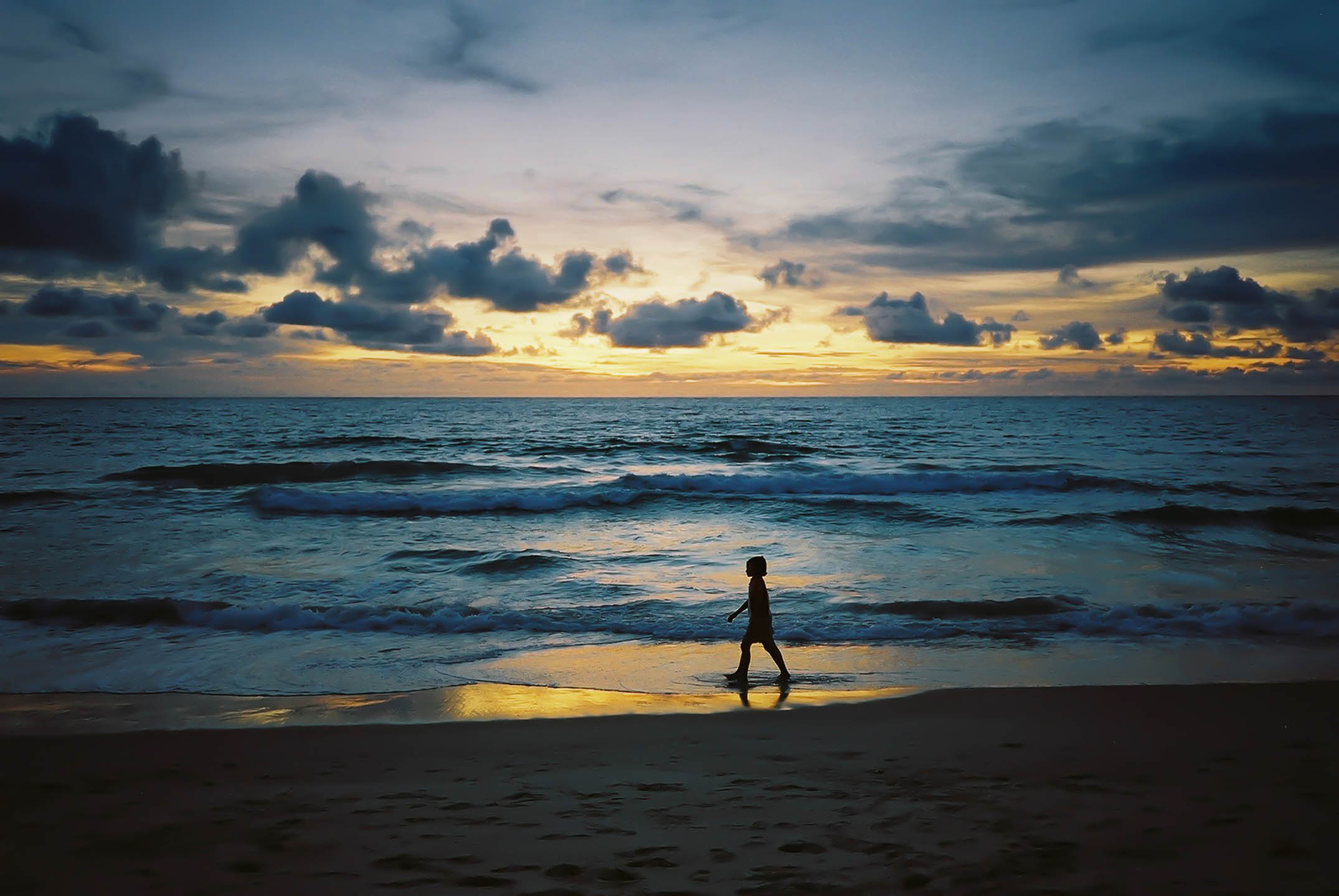 Young girl at sunset in Phuket, Thailand