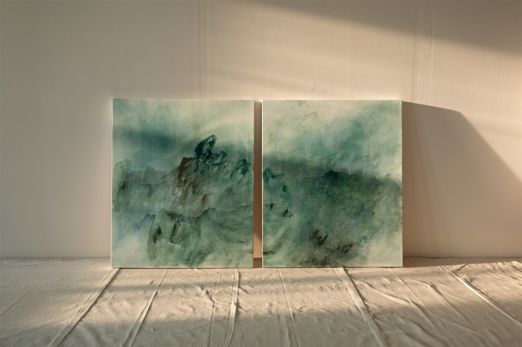 Diptych in green shades in slanting evening sunlight.