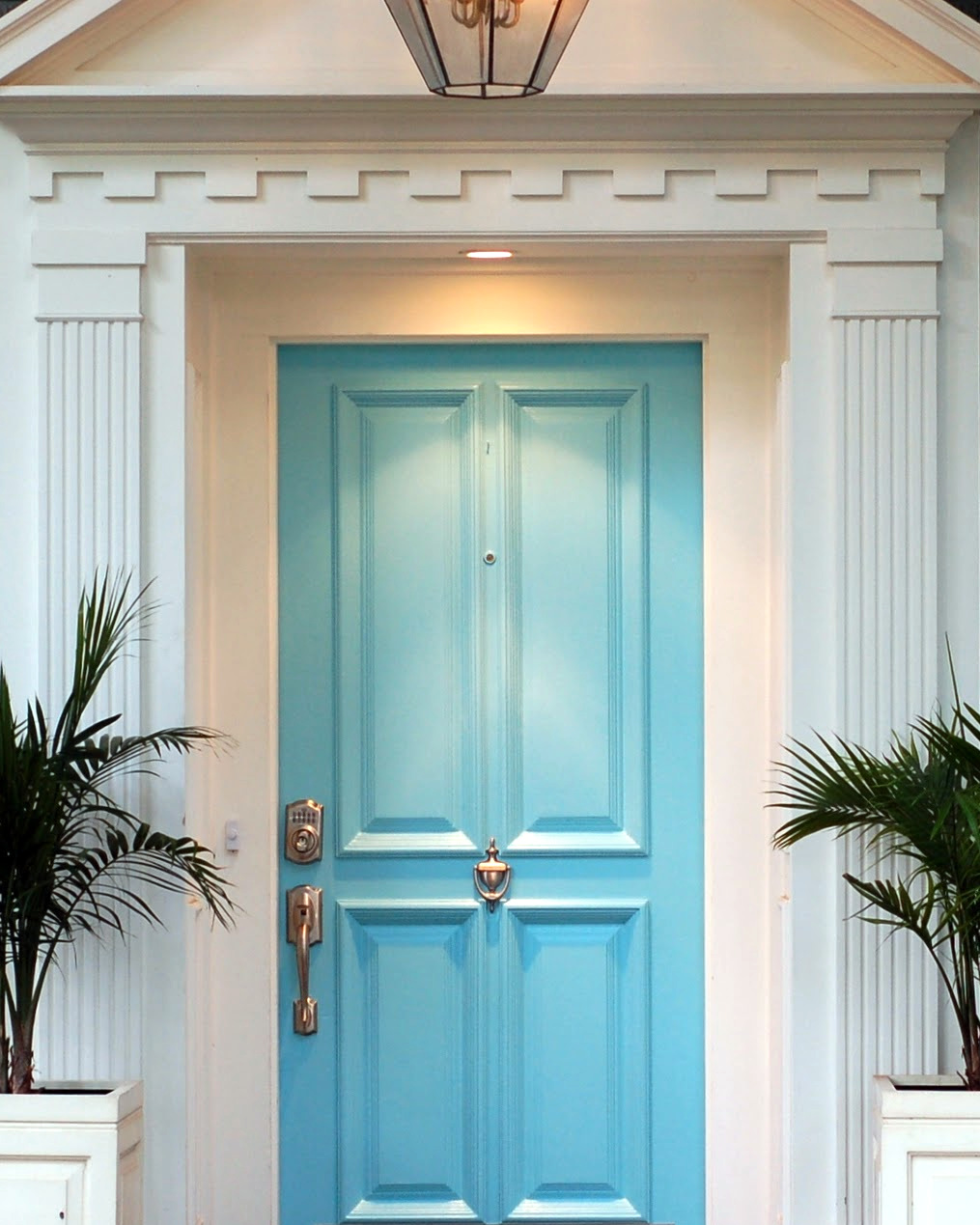 This light blue is so pretty, and it really looks sleek with the contrast of the off-white mill work. The columns and capitols adds to the elegant feel of this entry.