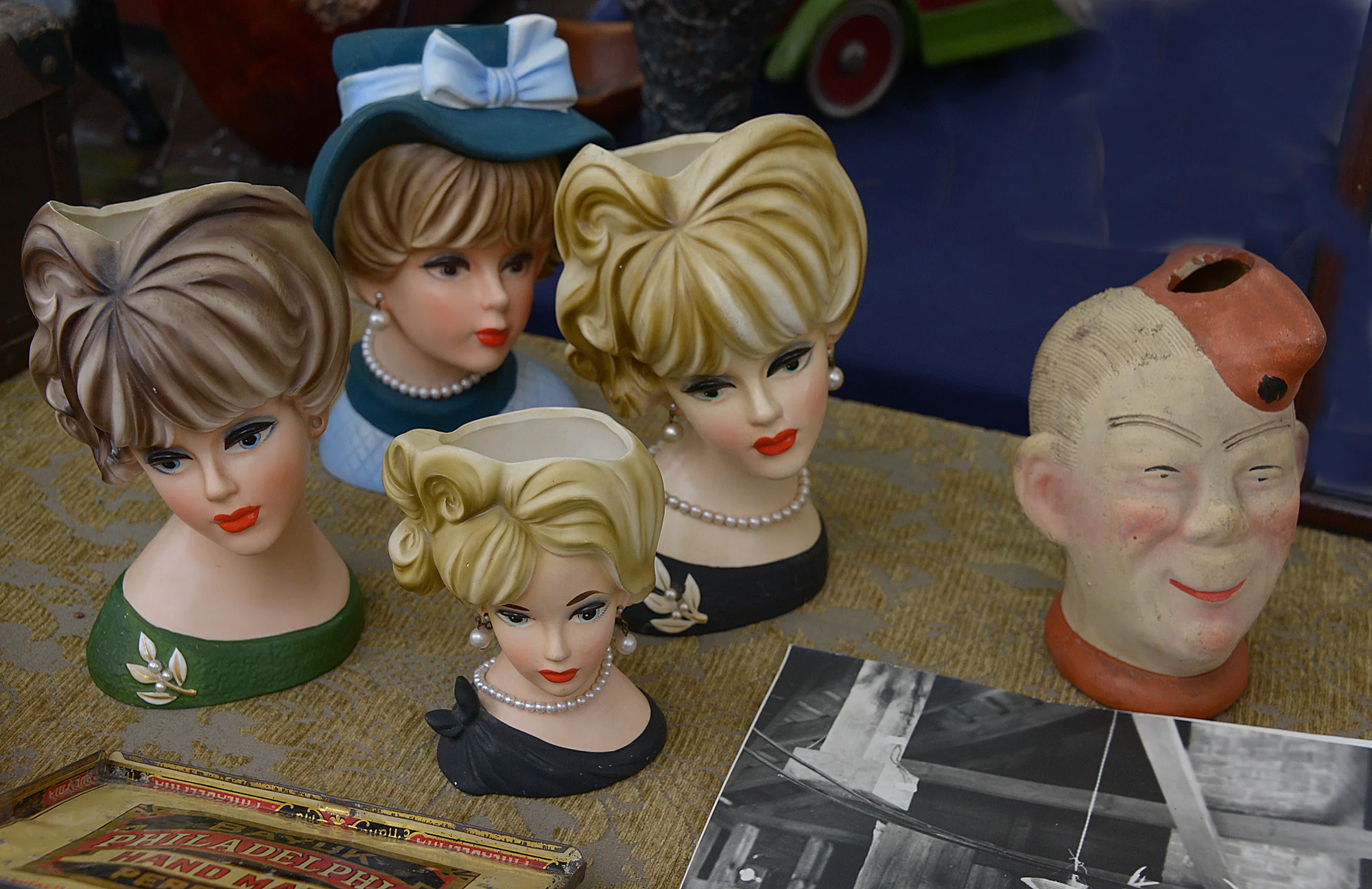 Brimfield Fleas May 2017 porcelain heads. Or plastic. And the photograph is curious.