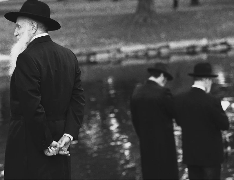 Tashlich ritual by orthodox families at elm park:celebrating thje casting of sins into the water at the start of the new year: Aharon Heresh,left; men reciting the Tashlich by the water