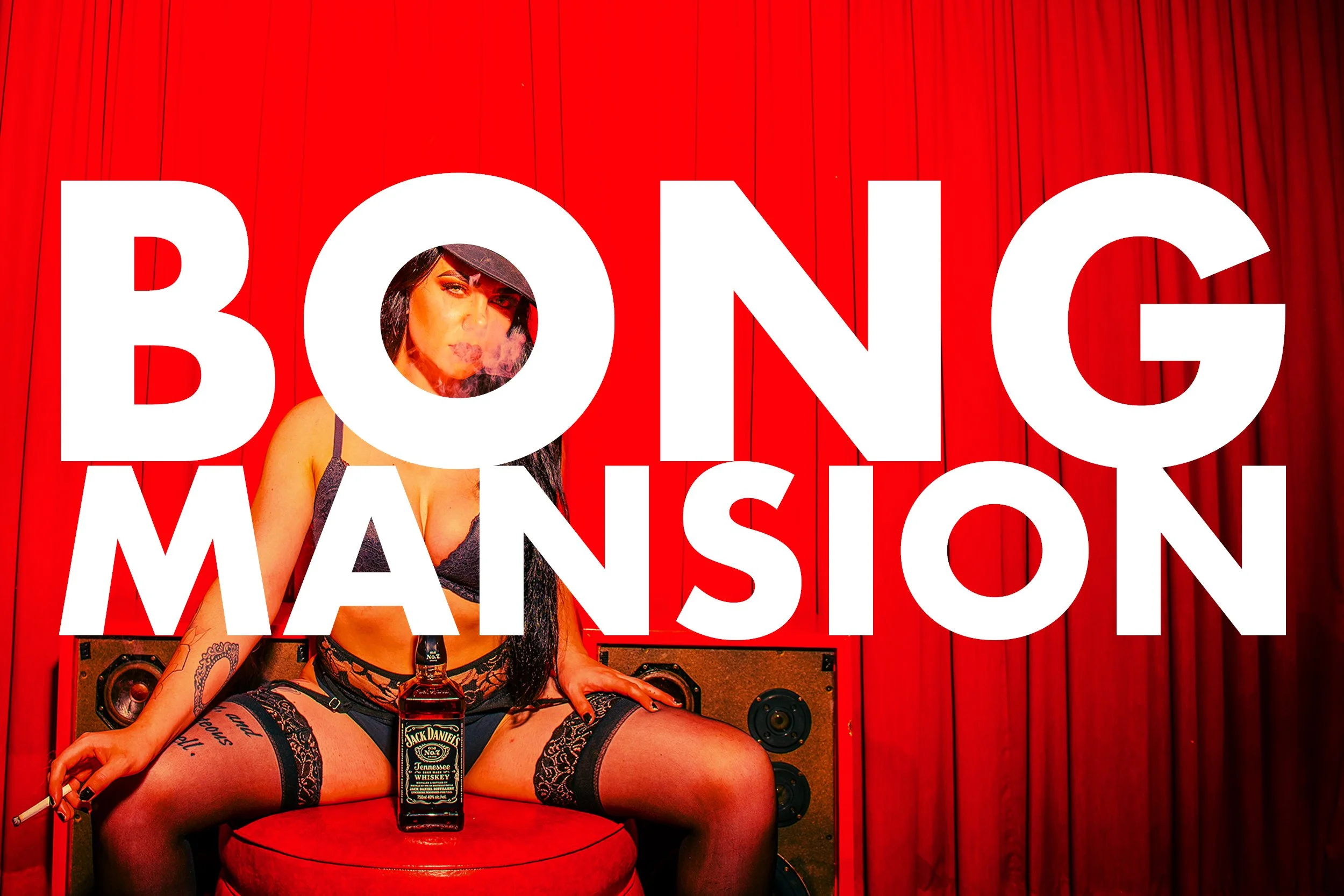 A woman with tattoos and dark hair is sitting on a red chair in front of a red curtain, holding a bottle of Jack Daniel's whiskey balanced on her exposed thigh. She is dressed in black lace lingerie, and there is a large, bold white text behind her t