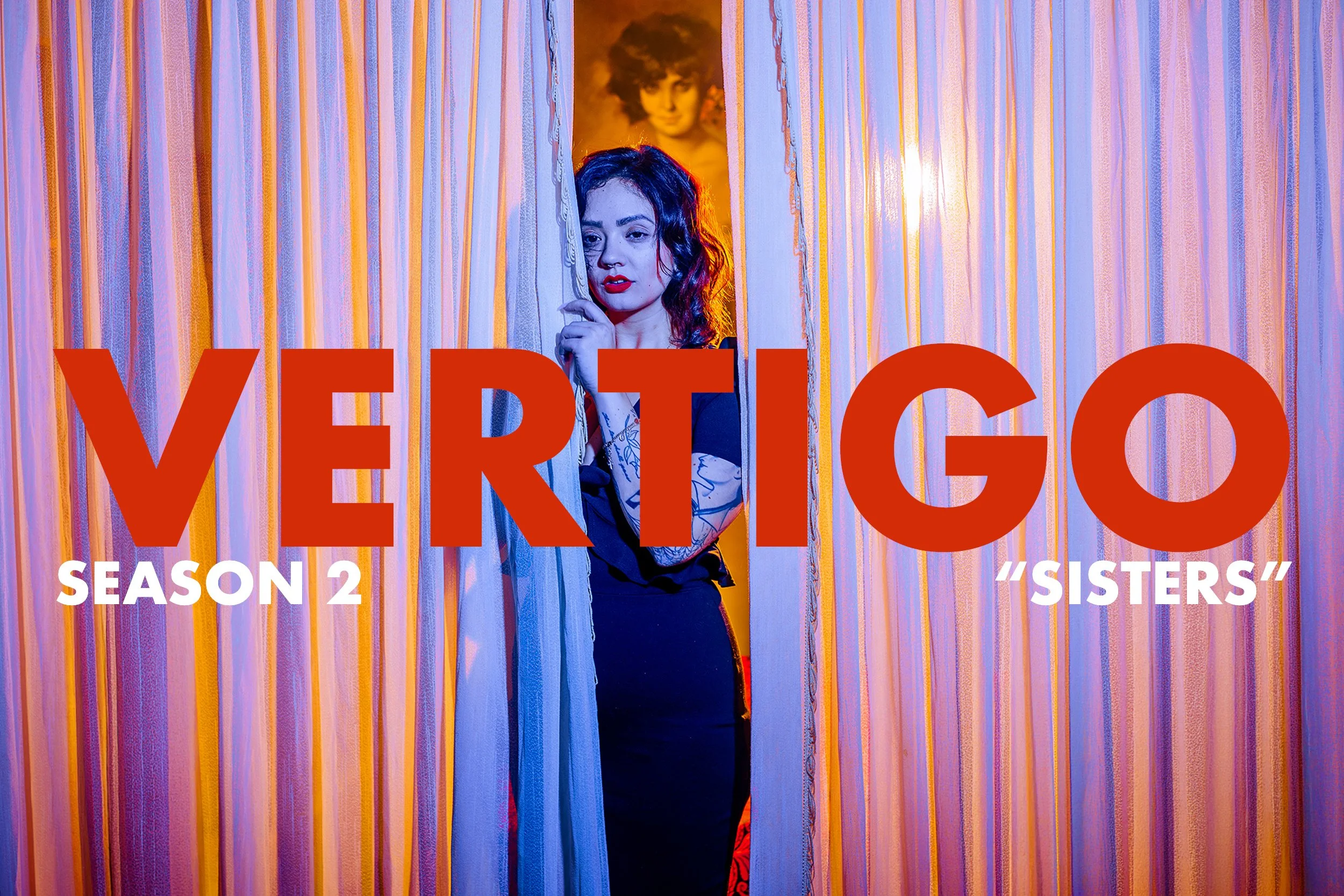 A woman with dark curly hair and tattoos peeking through curtains in front of a colorful background, with text indicating 'Vermont Season 2 Sisters'.
