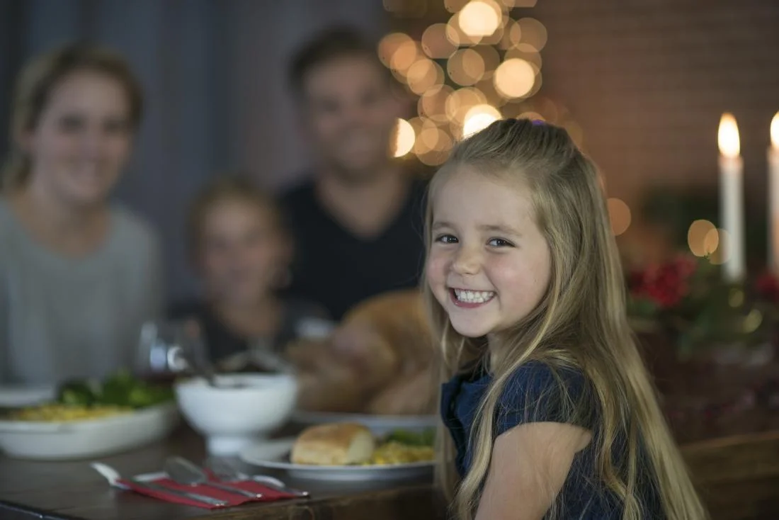 a-happy-child-eating-a-meal-with-her-family.jpg