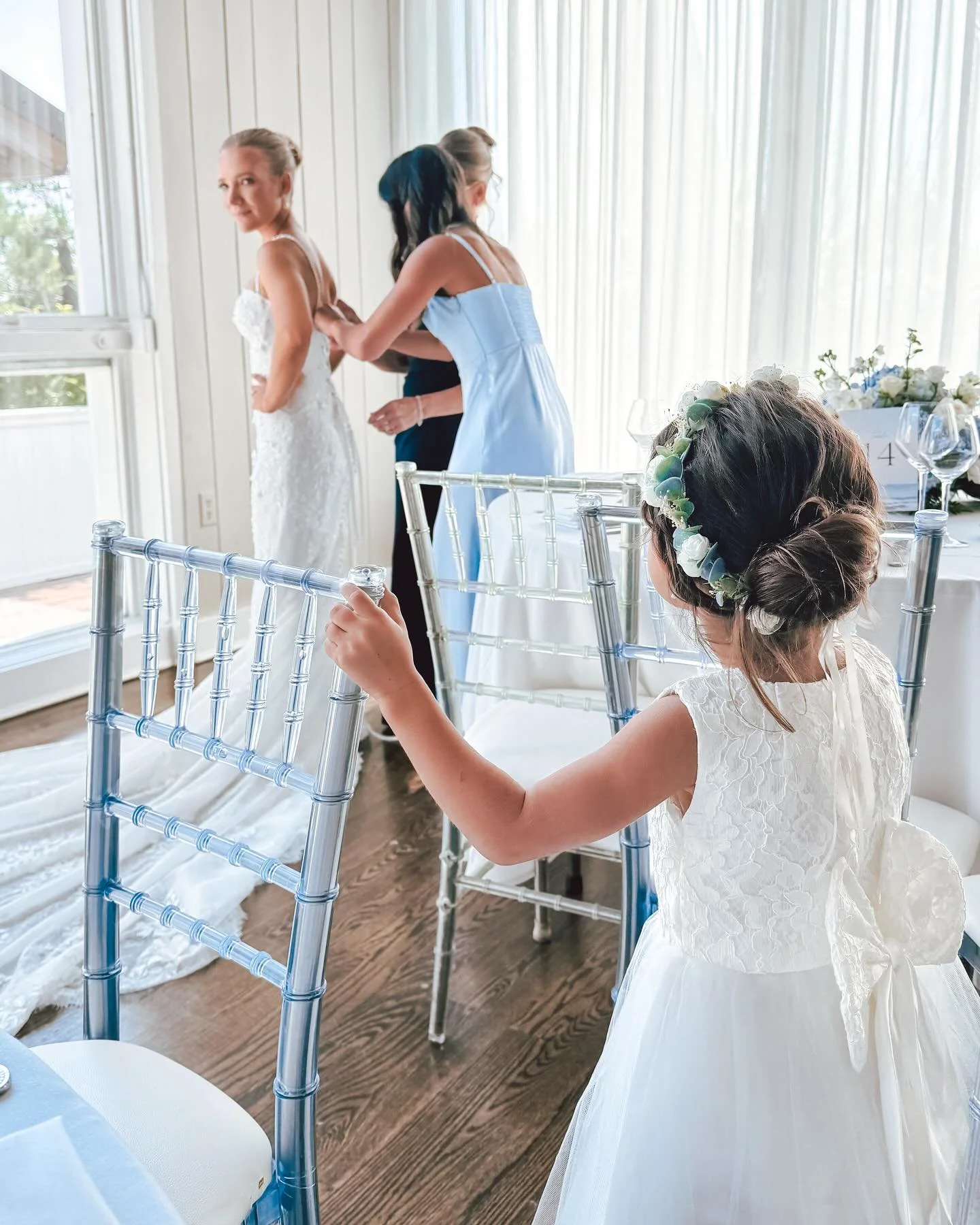 One of the most beautiful moments imaginable captured on camera &ndash; the flower girl observing multiple generations of amazing, beautiful women help @kiierabrooke get ready to walk down the aisle 🩵💍✨