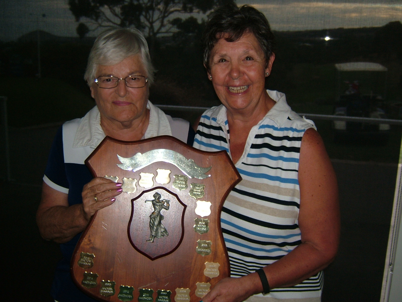 Faye WILLIS (VHGC Ladies Capt - Left) receiving the Ladies Trophy from Susan LEWIS (McCracken Ladies Capt).