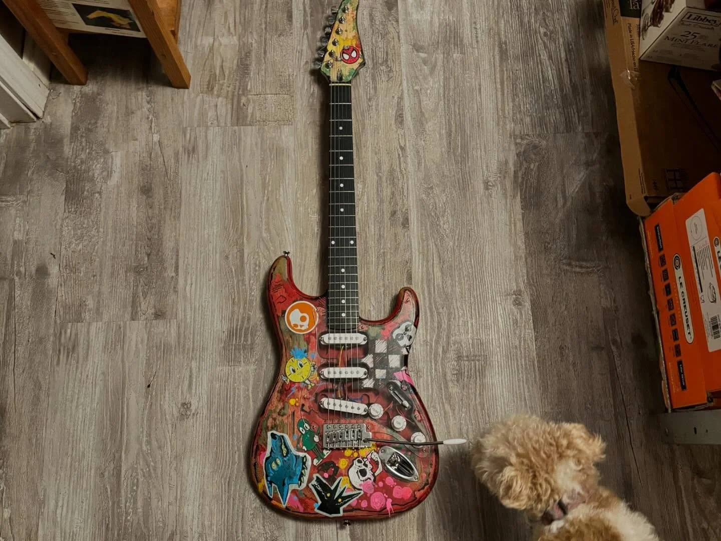 A few months back I decided to make a custom guitar to go with my Spider-Punk costume. Got a simple kit off Amazon and spent 24 hours painting, roughing up, adding stickers and clear pick guard to it. Based off the guitar on Spiderverse but on a Stra