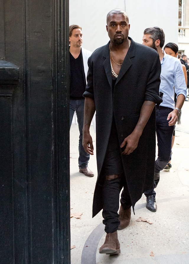 Kanye West at Paris Fashion Week September 2014. Wearing wool overcoat and Chelsea Boots ( Botegga Veneta)