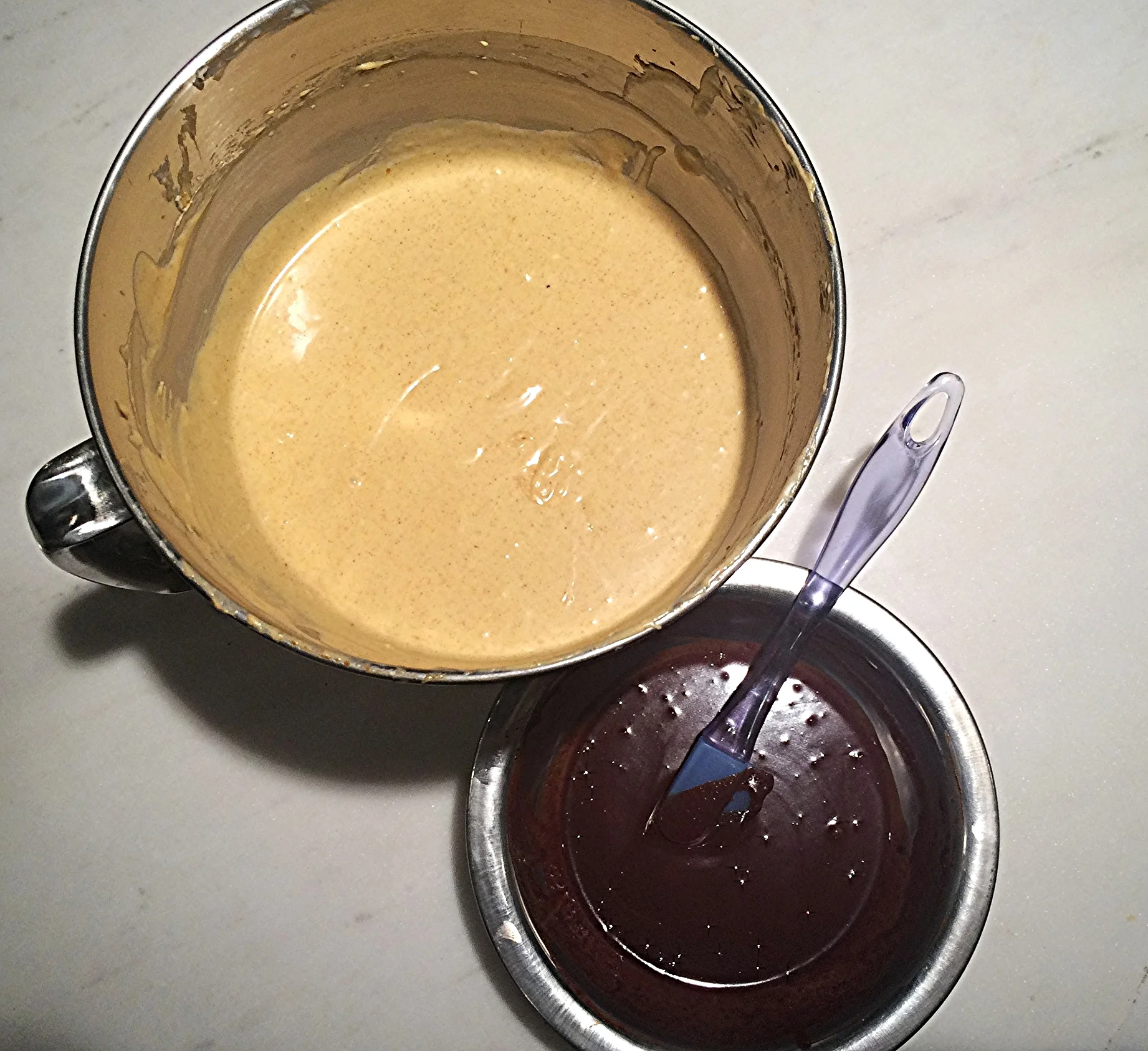 Com a massa de abóbora pronta e o chocolate derretido, incorporado ao creme de leite e frio, separe uma xícara da mistura de cream cheese numa outra tigela e adicione o chocolate derretido. Misture delicadamente até que fique homogêneo. 