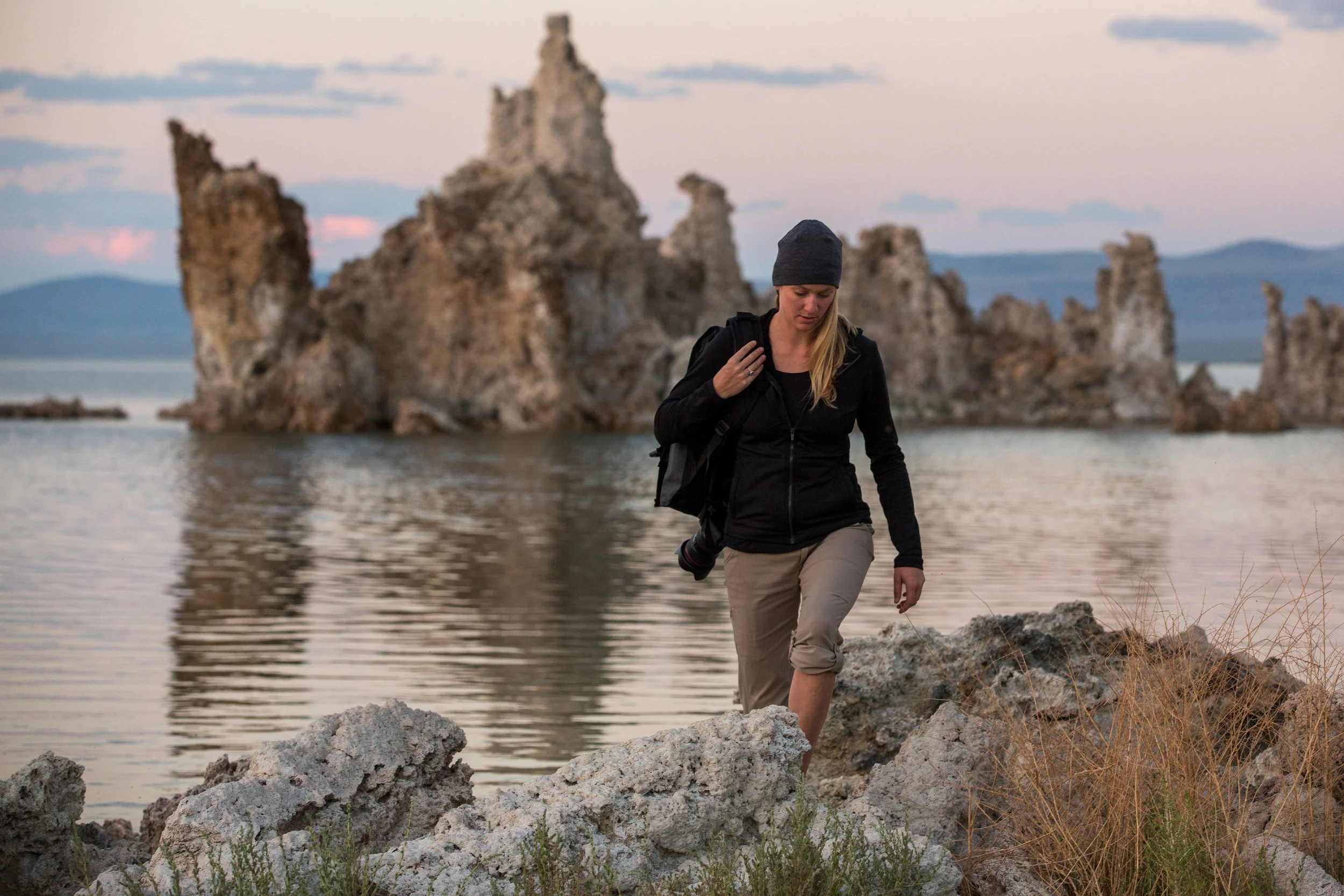  Young woman hikes with a camera at South Lake Tufa Area, Mono Lake, California. 