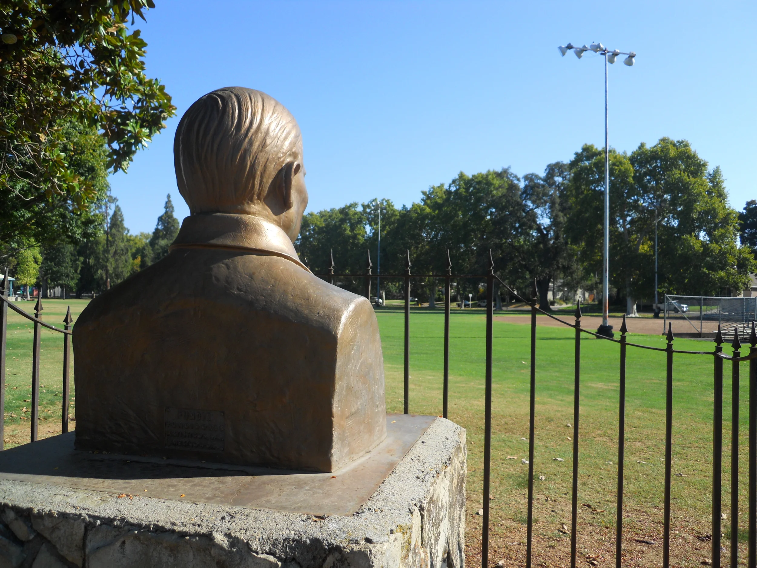Statue of Benito Juarez keeps watch over the baseball diamond at Royer Park along Douglas Boulevard