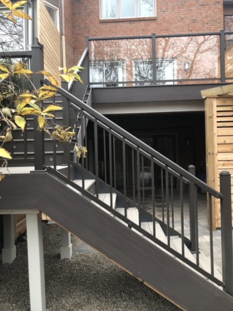 A deck and backyard stairs made of durable composite decking
