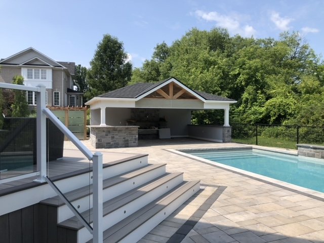 A backyard oasis with decking, stairs and a covered patio area