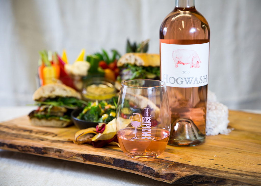 McEwan's Rosé Picnic's Vegan Picnic Basket. Fire roasted eggplant sandwich with spiced chick pea spread, roasted Ontario peppers, sweet pickled onion, pesto aioli on olive ciabatta roll. Seasonal vegetable crudités with classic hummus. Grilled broccoli salad with roasted corn salsa. Crisp root vegetable chips. Double chocolate coconut cake.