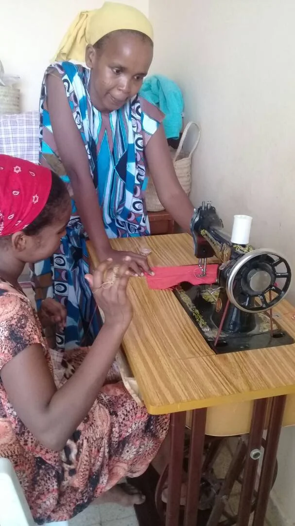 One of the summer partcipants learning how to sew