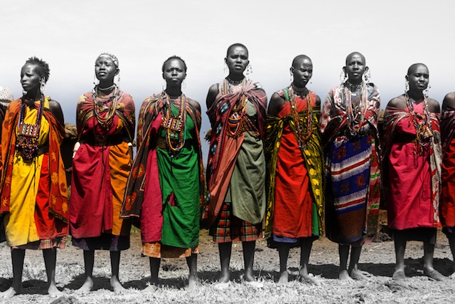 East African women wearing the traditional kanga , a fabric wrap that often has thoughts or sentiments printed on the fabric. Wearing kangas with printed thoughts allows women to subvert cultural dicta preventing them from speaking frankly. Thank you, Ziddi Msangi, for your amazing work on the topic.