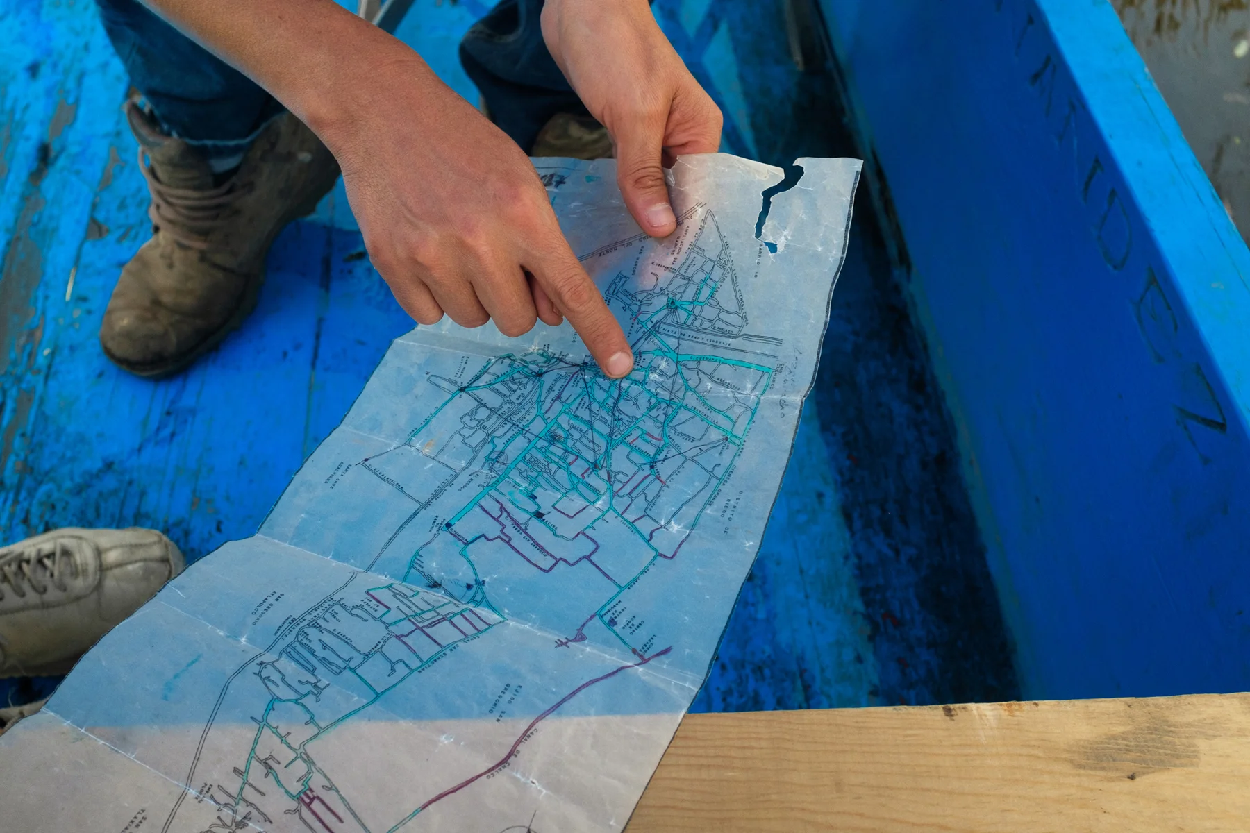 March 3, 2018 - Mexico City, Mexico: Carlos Maravilla Santos, co-founder of Plan Acalli, traces currently passable routes on an intricate map of the canals of Xochimilco. (GOOD Magazine/Mallika Vora). (GOOD Magazine/Mallika Vora)