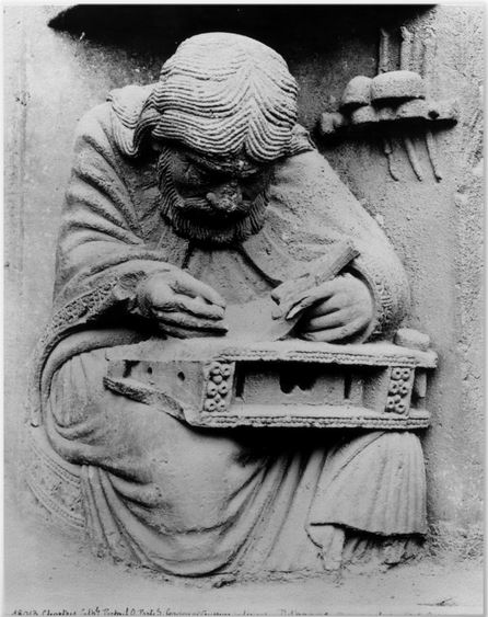 The figure of Pythagoras studying the divine laws of harmony , Chartres Cathedral, Royal Portal, west façade, right doorway tympanum, under the figure of the Virgin inside a Vesica Piscis. 