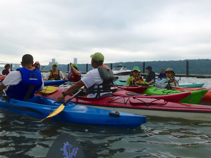Gathering for a pre-paddle talk on the water.