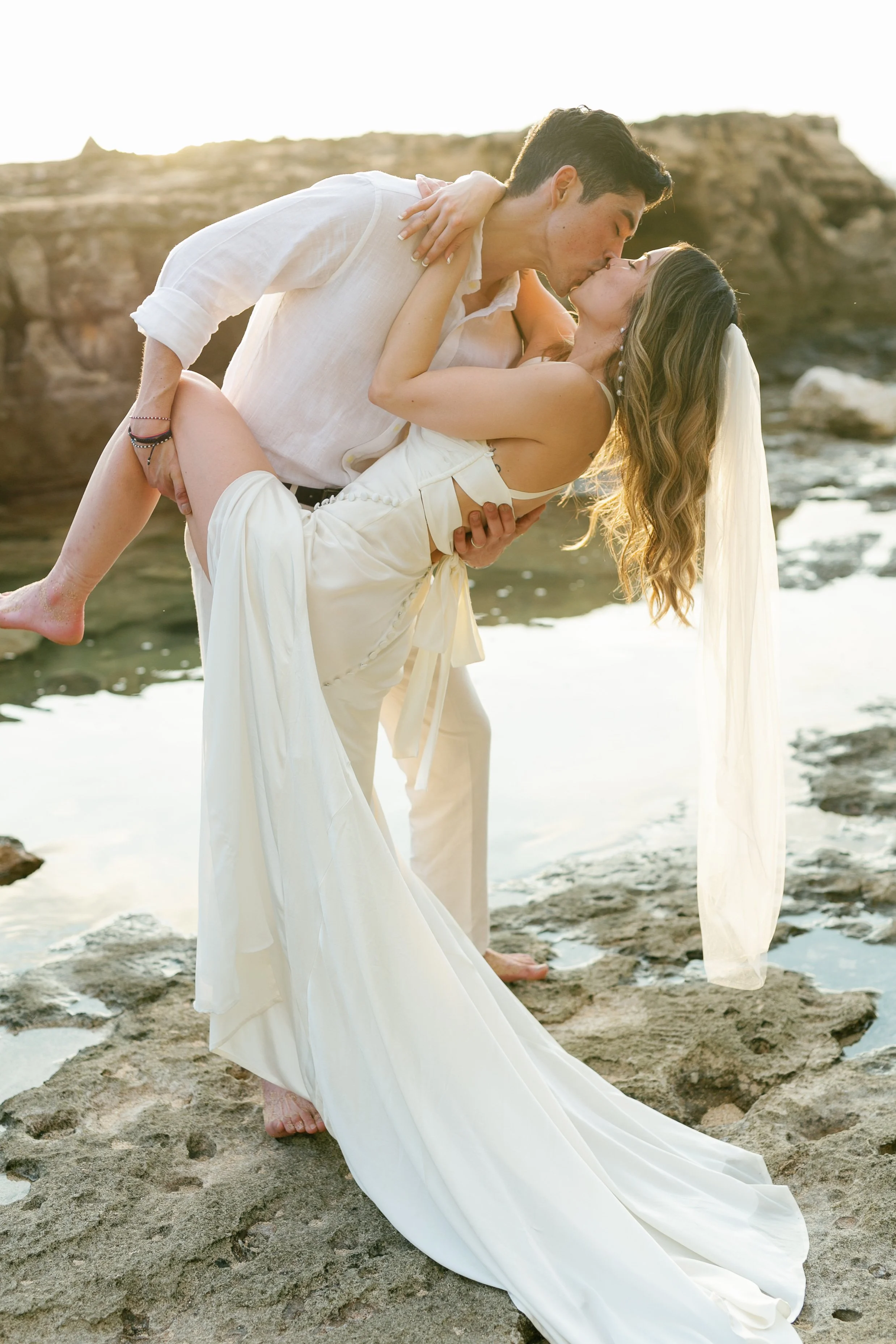 Wedding embracing at sunset at Hawaii elopement