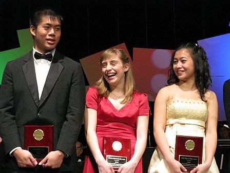 Three happy soloists receiving their awards