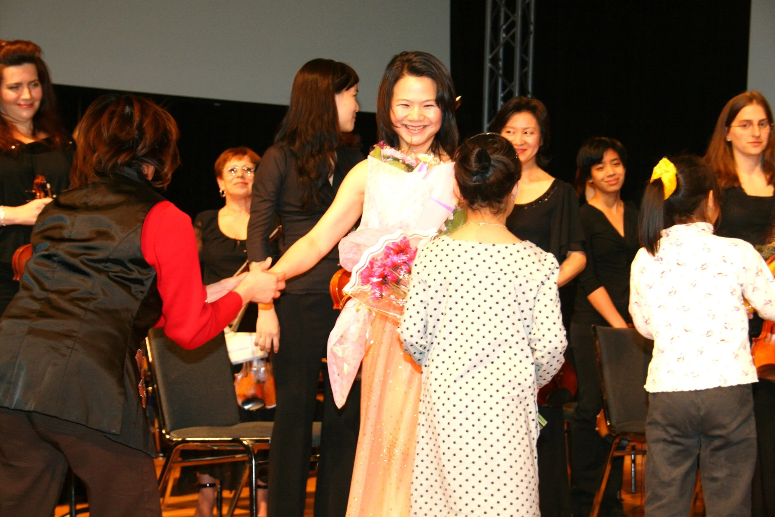 Stella Xu receiving flowers from her many admirers