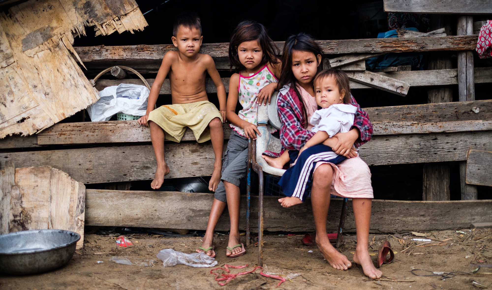 Kim Chantha's children sit outside their family home inside the Boeung Kak lake development area. One of the few remaining houses from a community of over 4000 families.