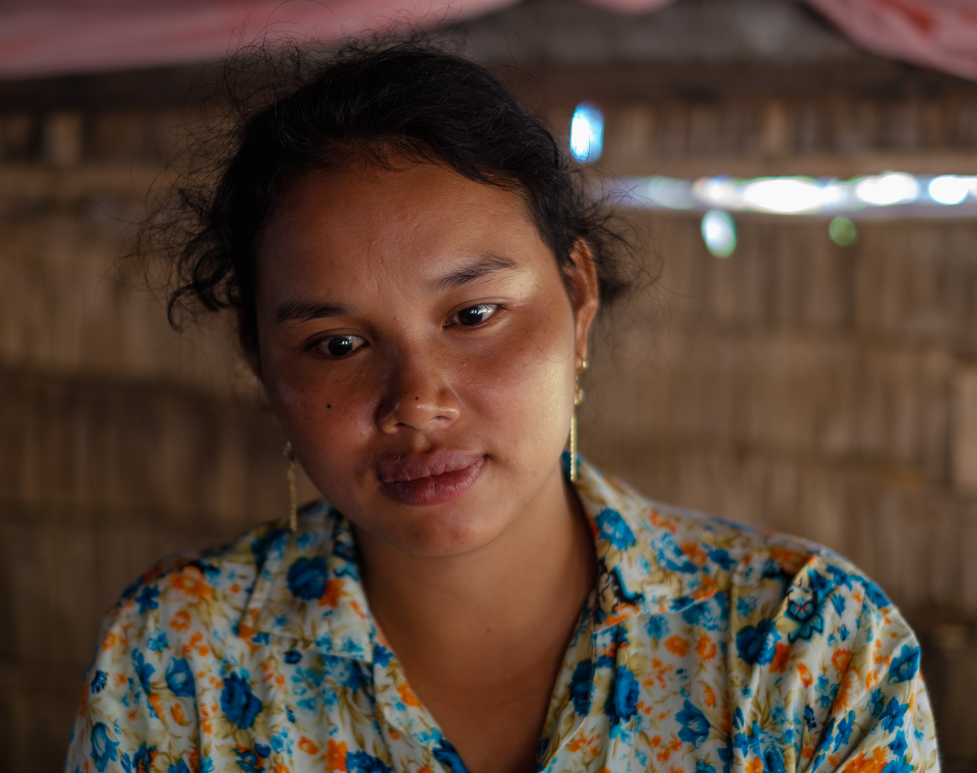 A portrait of Neth Sokha. Since her accident, the 28 year old garment facotry worker has been unable to return to work. She has been in the industry for 11 years.