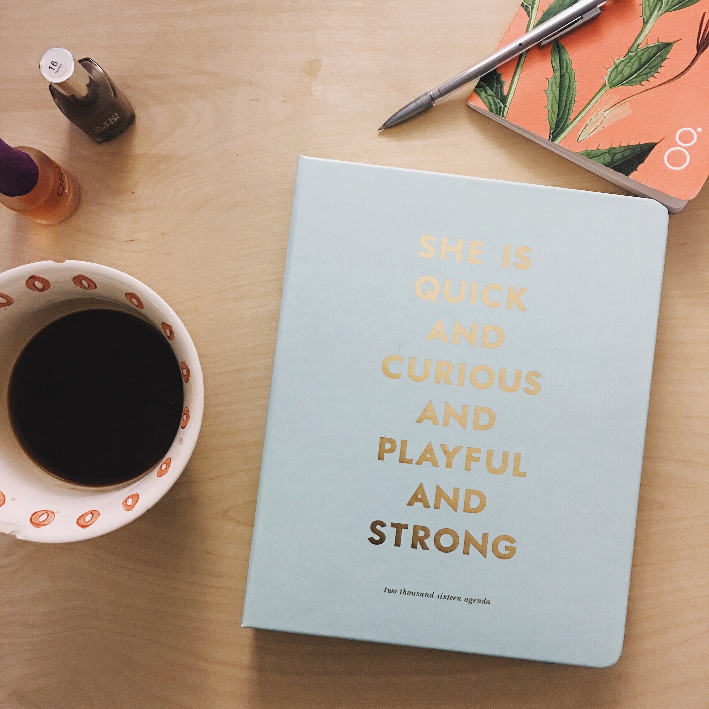 Coffee, day planner, and notebook are essentials!